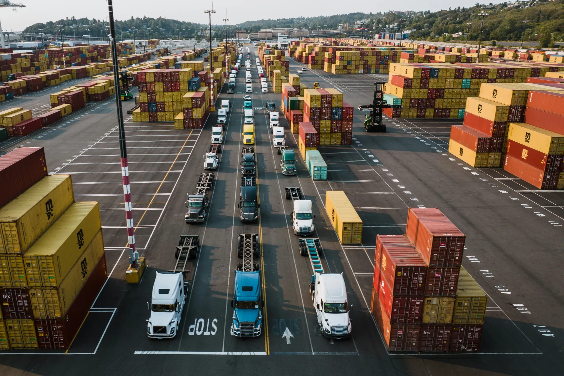 Parked trucks awaiting cargo containers for distribution.