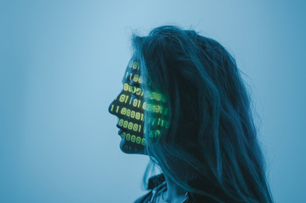 Silhouette of a woman with binary projected on her face representing user-friendly computer interfaces