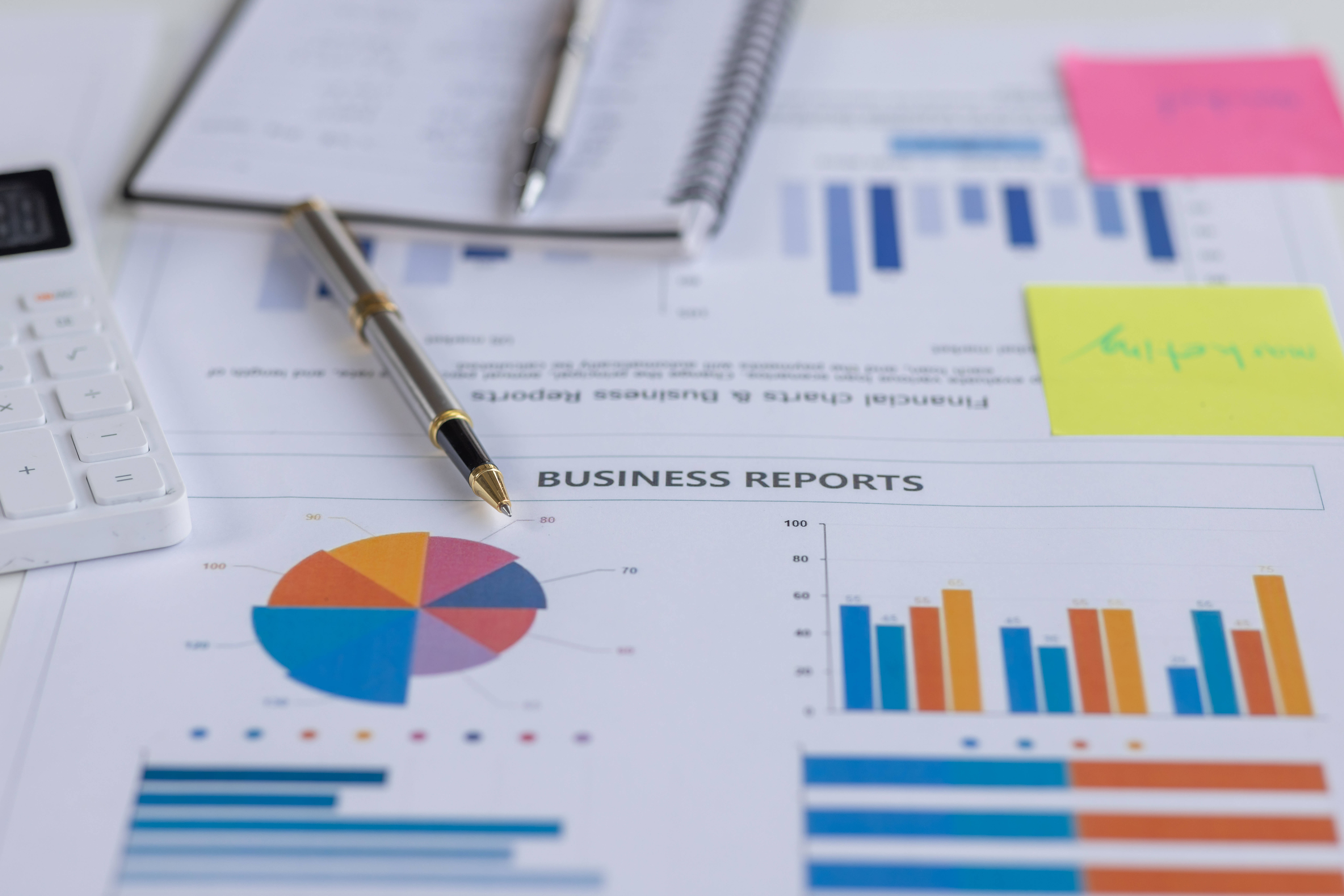 Colorful business reports with pie charts and histograms