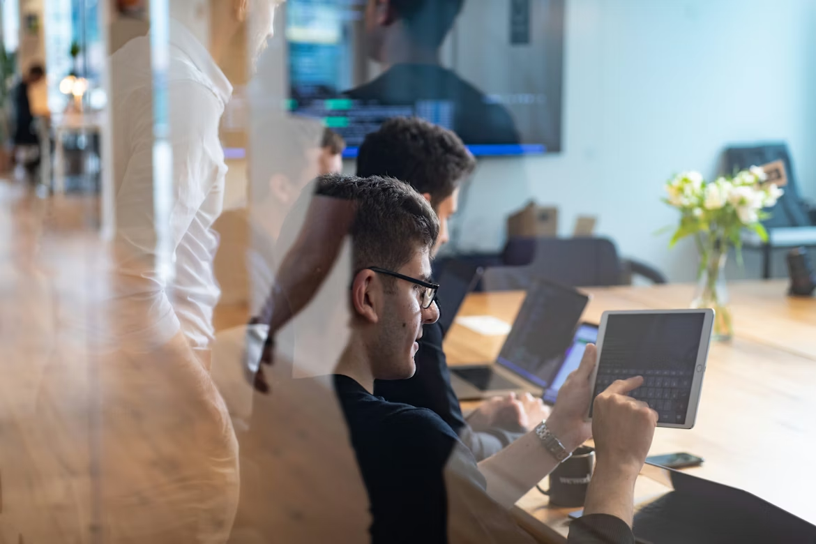 Software professionals using mobile computers while working in an office